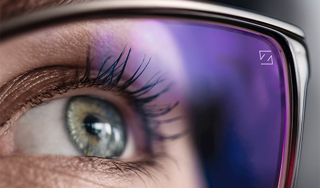 Close-up of an eye behind a coated prescription lens